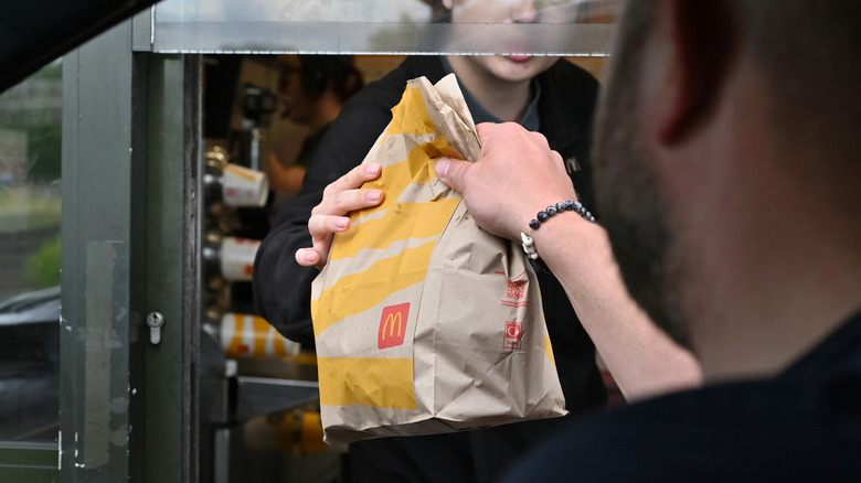 person picking up order at McDonald's drive-thru