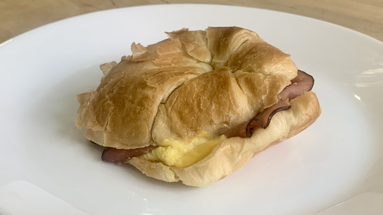 Ham Croissan'wich on white plate with wood background