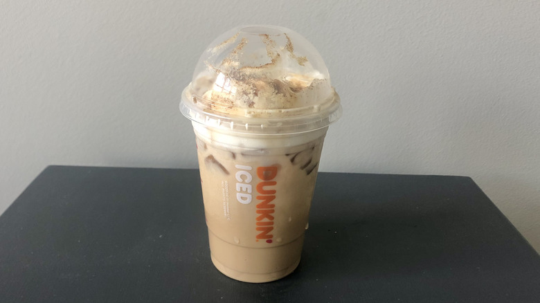 Dunkin' Donuts iced pumpkin spice latte in a plastic cup