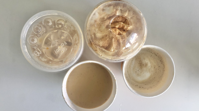 Top-down view of hot and iced pumpkin spice lattes from McDonald's and Dunkin'