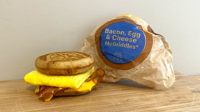 Bacon, Egg and Cheese McGriddles next to a McDonalds wrapper.