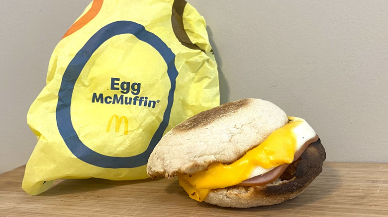 Egg McMuffin next to a McDonald's wrapper.