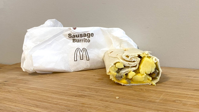 Sausage Burrito next to a McDonalds wrapper.
