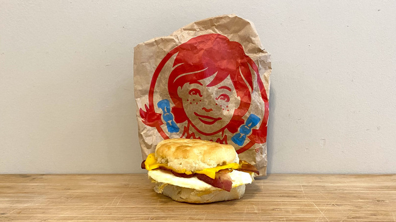 Bacon, Egg and Cheese Biscuit in front of a Wendy's wrapper.
