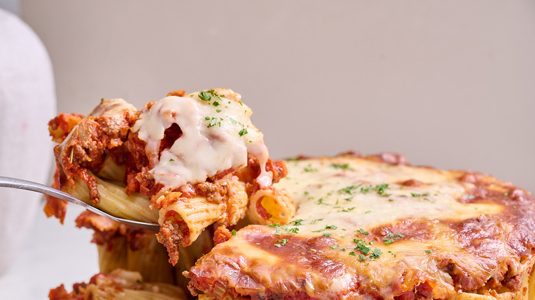 spoon lifting pasta out of pan