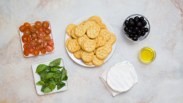 Mediterranean cracker sandwich ingredients on table