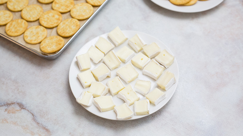 sliced Brie on white plate