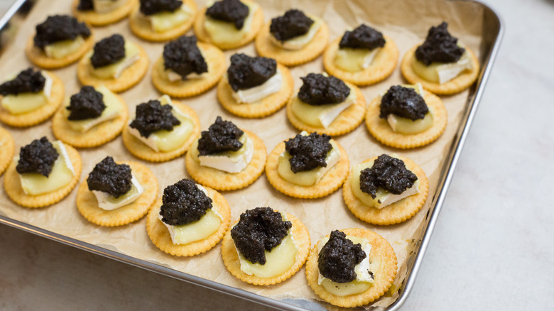 loaded crackers on baking sheet