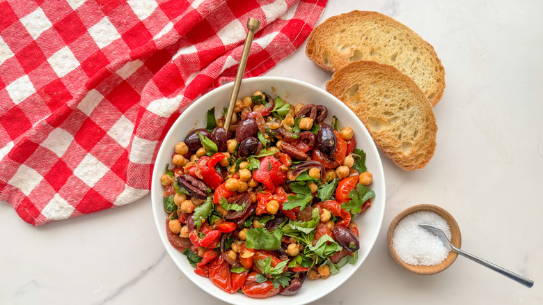 Mediterranean chickpea skillet serving next to slices of bread