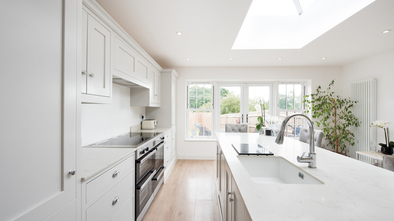 Kitchen interior with white walls and wooden flooring