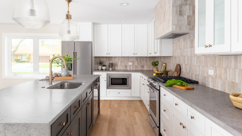 Kitchen interior with stone countertops and white walls