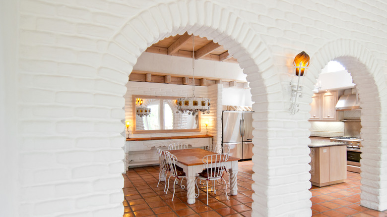 White arched room dividers separating the kitchen from the living room