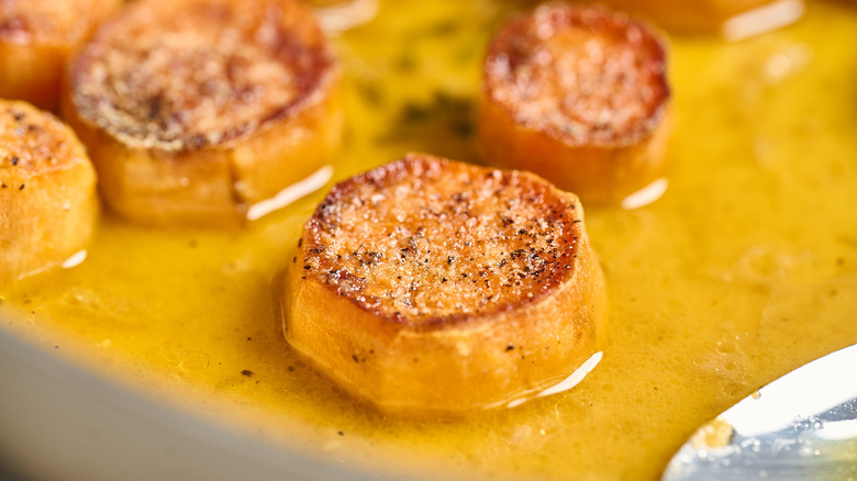 melting sweet potato in broth in a pan