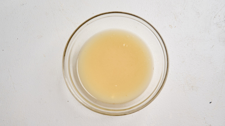 broth and mustard combined in a bowl