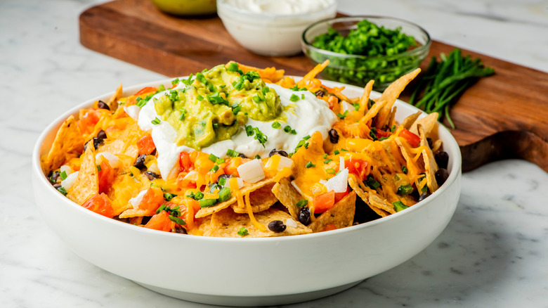 bowl of nachos with sour cream