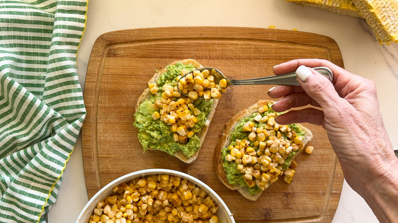 hand adding elote mixture