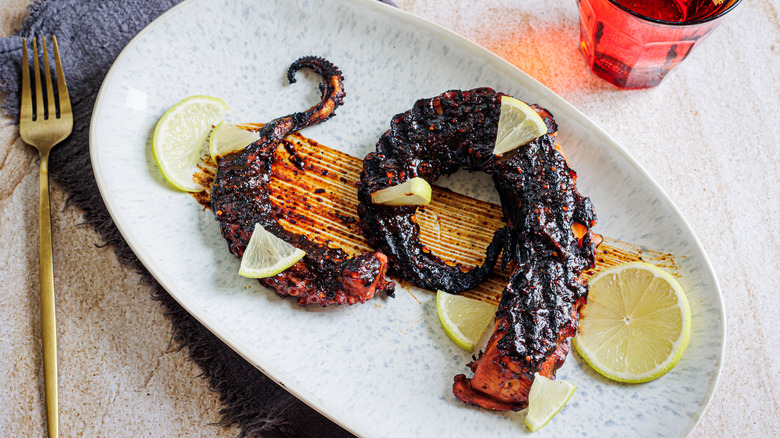 grilled octopus on blue plate