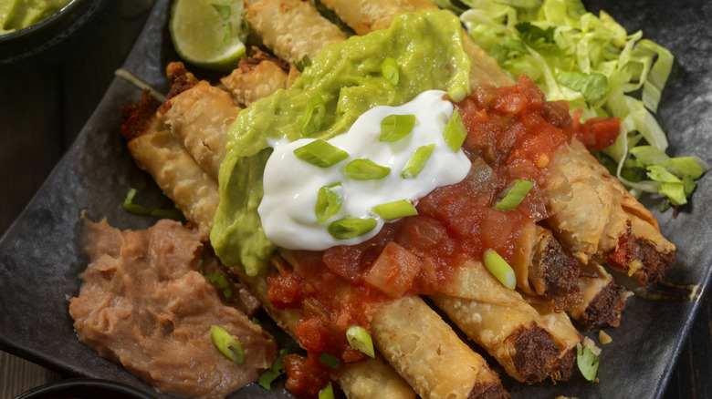 Taquitos smothered in salsa