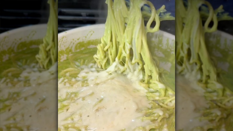 close up of sauce with spaghetti noodles and melted cheese