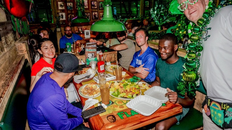 Young people eating nachos and other items at Flanigan's on St. Patrick's Day