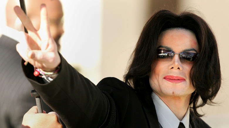 Michael Jackson smiling ad giving peace sign