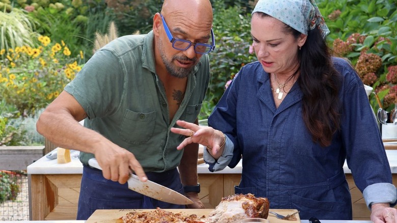 Michael Symon using knife in outdoor kitchen