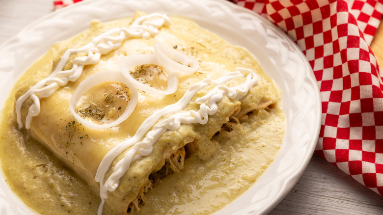 Enchiladas on a plate with onions