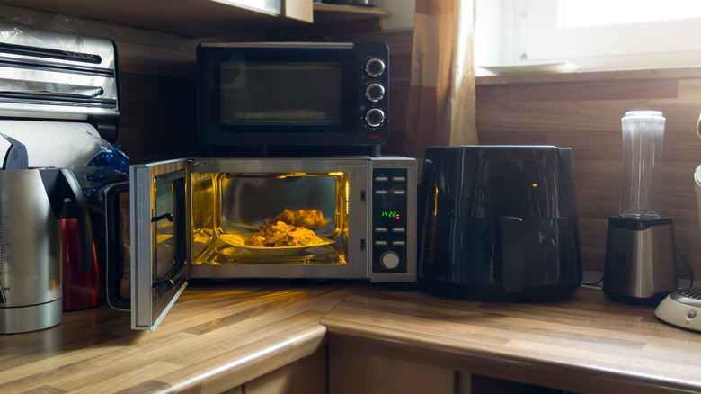 Kitchen counter with an air fryer, a microwave, and a toaster oven