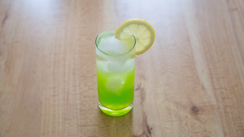 Midori sour on wooden table