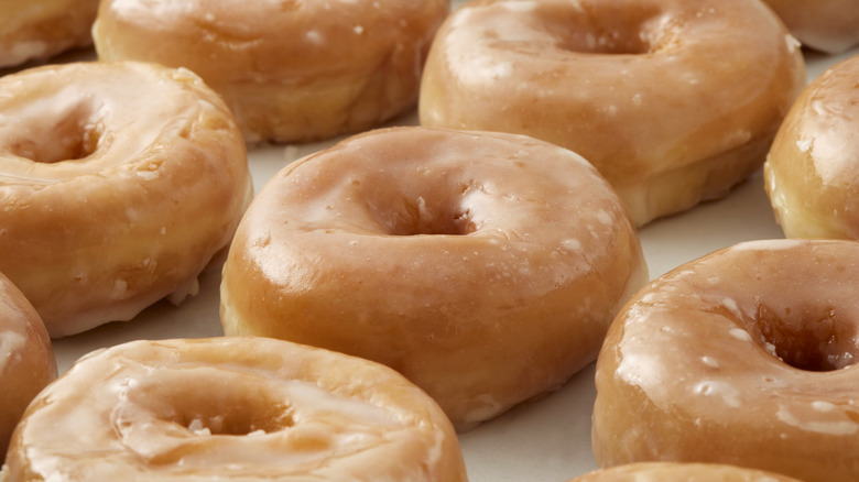 close up of glazed donuts in box