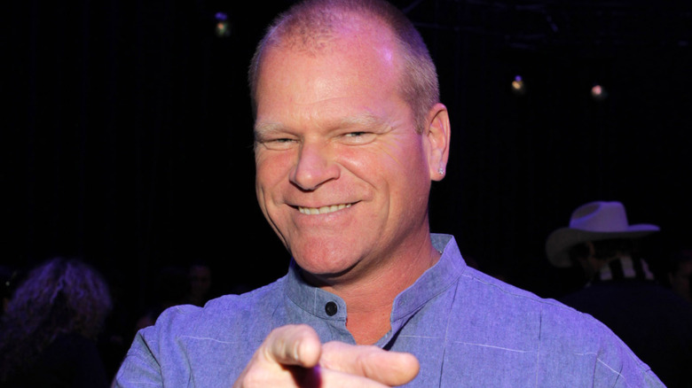 Mike Holmes smiling against a dark backdrop