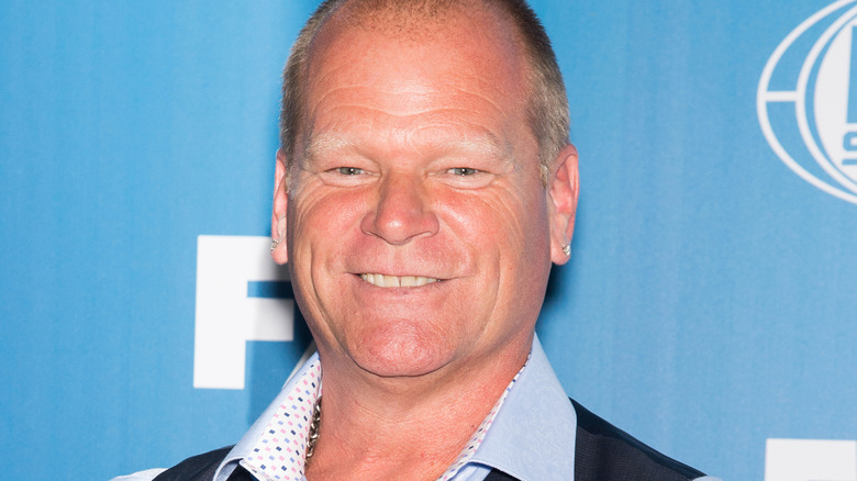 Mike Holmes smiles in collared shirt