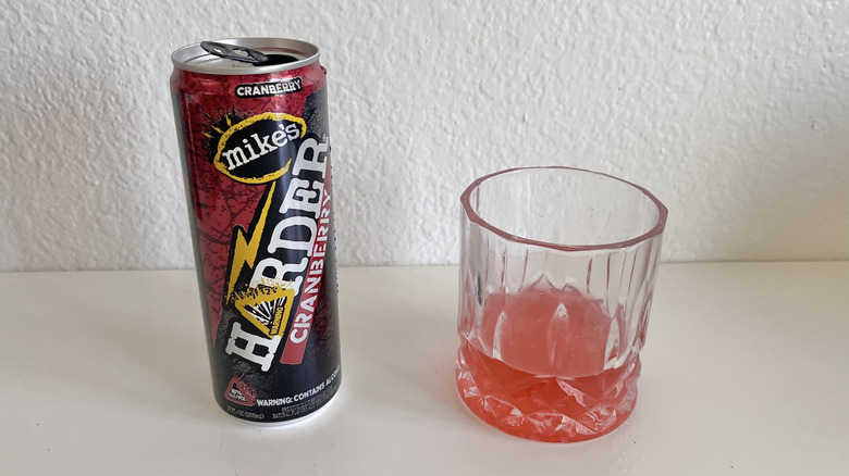 Harder Cranberry can on a table next to a glass