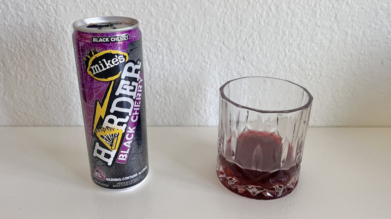 Harder Black Cherry can on a table next to a glass