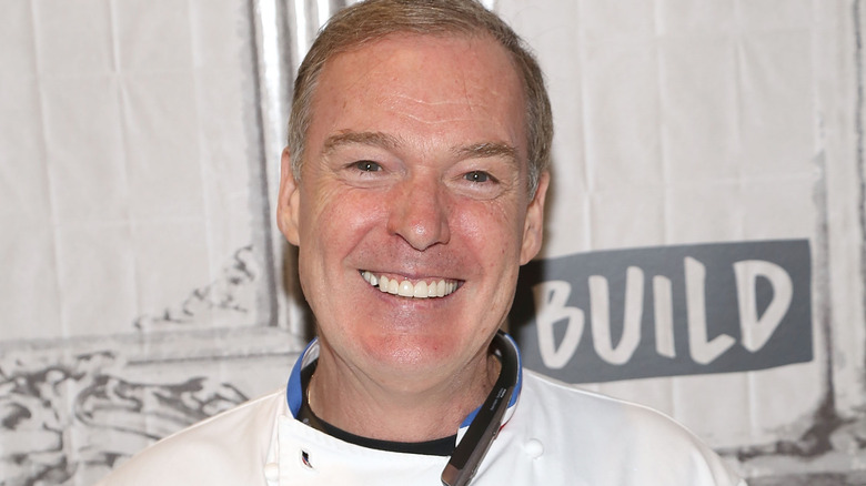 Jacques Torres smiling in suit and bowtie