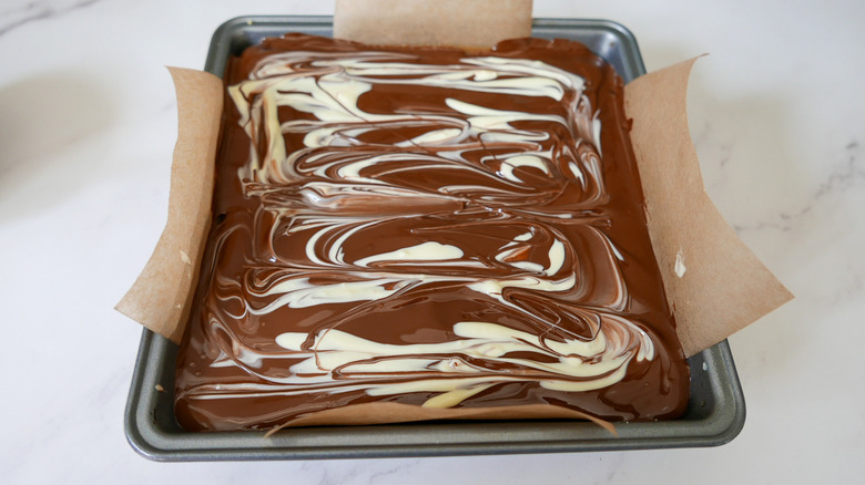 A baking dish full of uncut Millionaire's shortbread cookies.