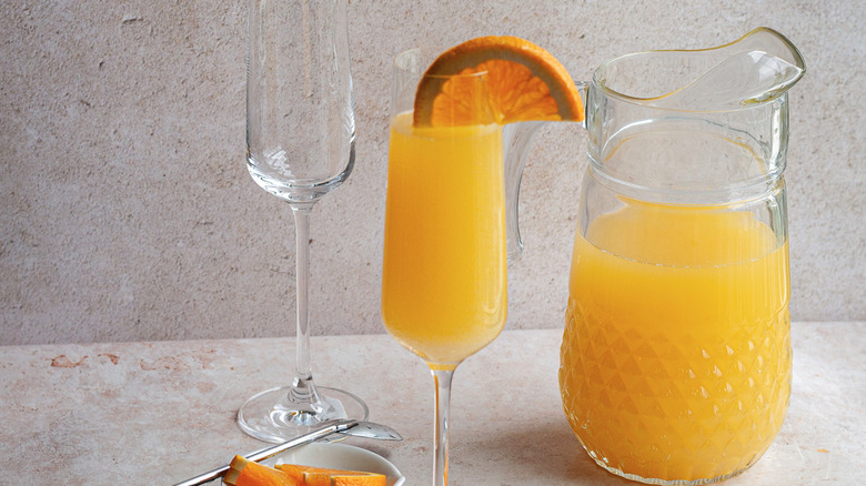 mimosas in pitcher and flute