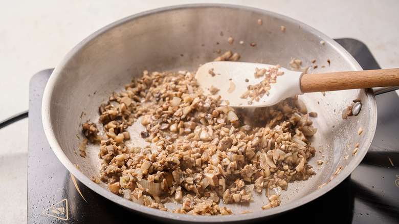 cooking the mushrooms and aromatics in a skillet