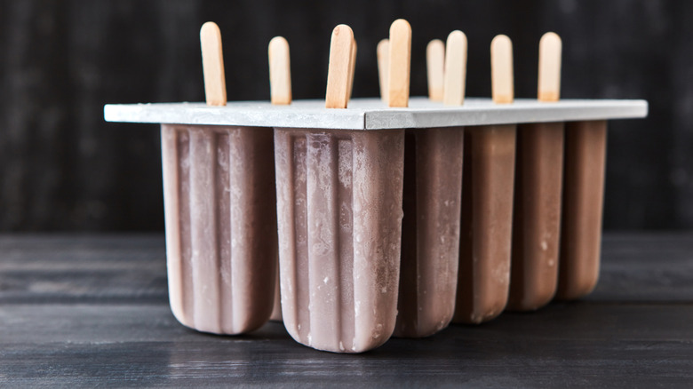 Molds filled with chocolate popsicles