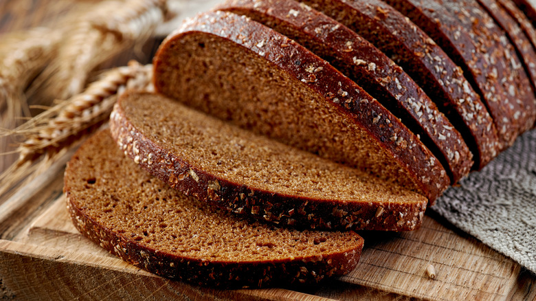 Sliced rye bread on a wooden cutting board