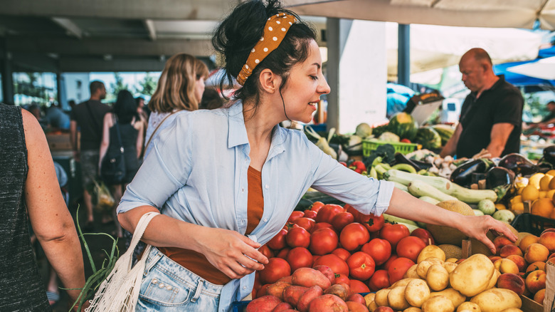 Person buying fresh produce at farmers market