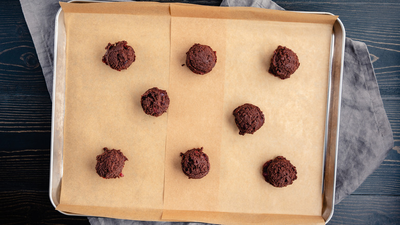 Parchment paper with cookie dough on baking sheet