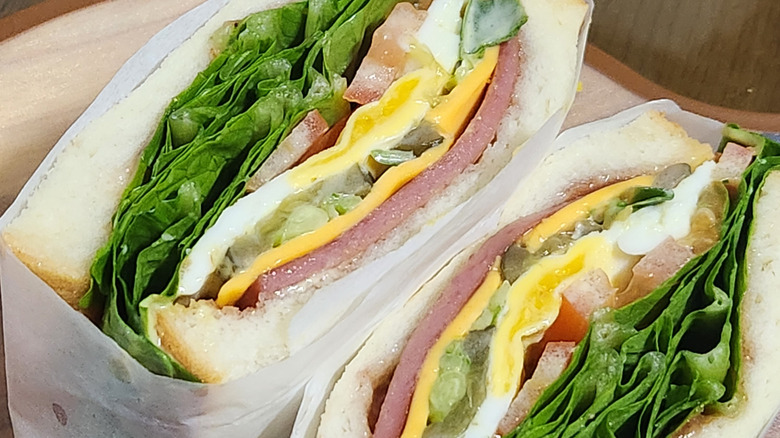 Sandwich cut in half and wrapped in parchment paper