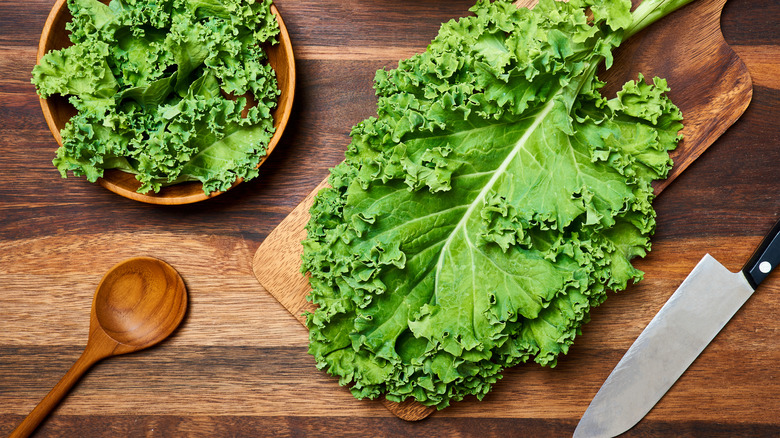 Kale leaves on a wooden cutting board 