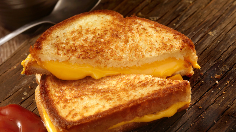 Closeup of grilled cheese sandwich on a cutting board
