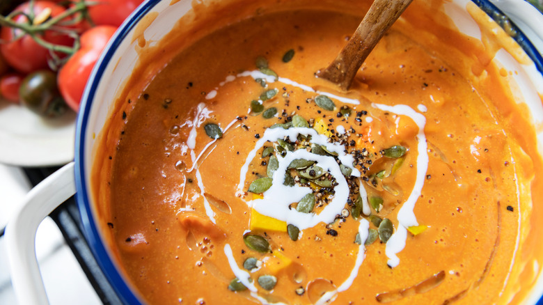 Overhead view of tomato soup simmering in a pot of the stovetop