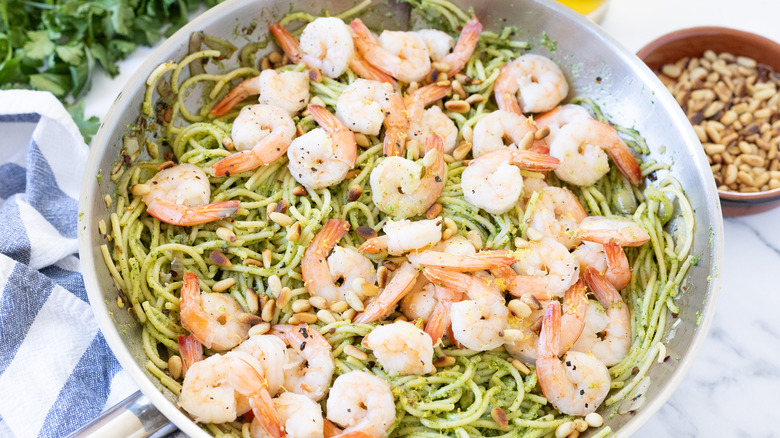Pesto shrimp pasta in pan.