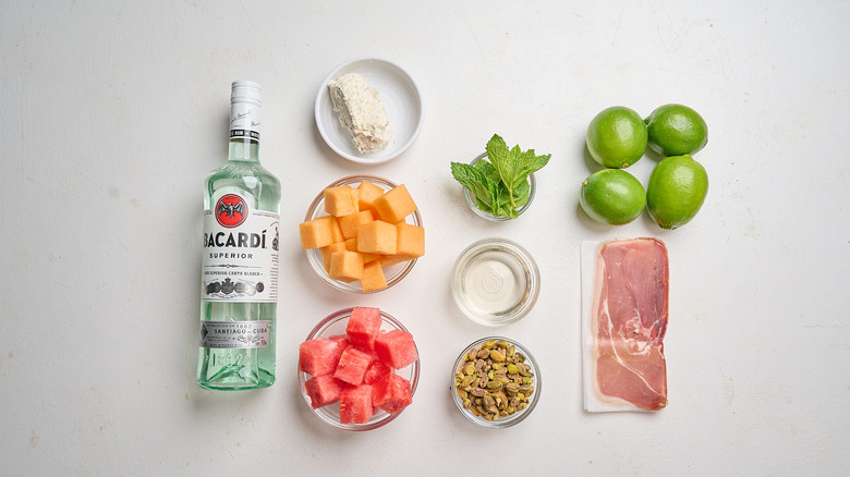 Mojito melon prosciutto skewer ingredients on a table