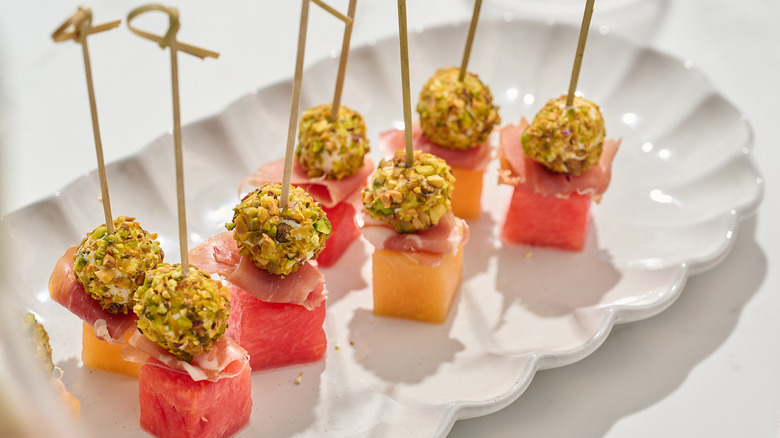 melon and prosciutto skewers on a platter