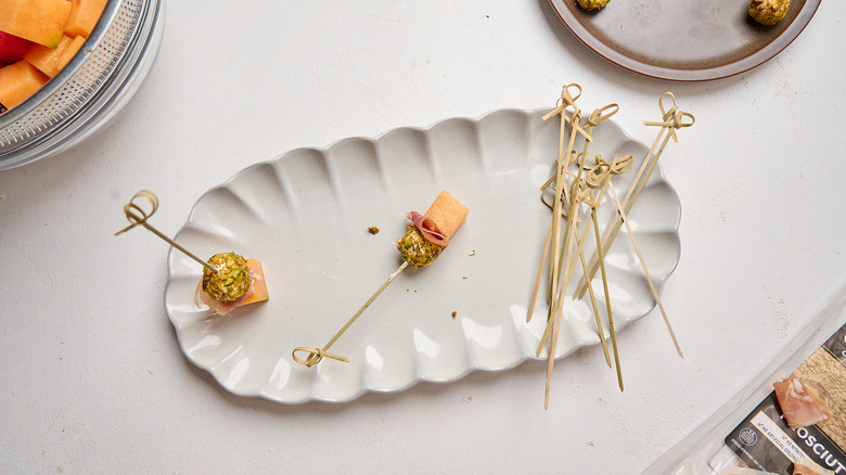 melon added to skewer with prosciutto and goat cheese